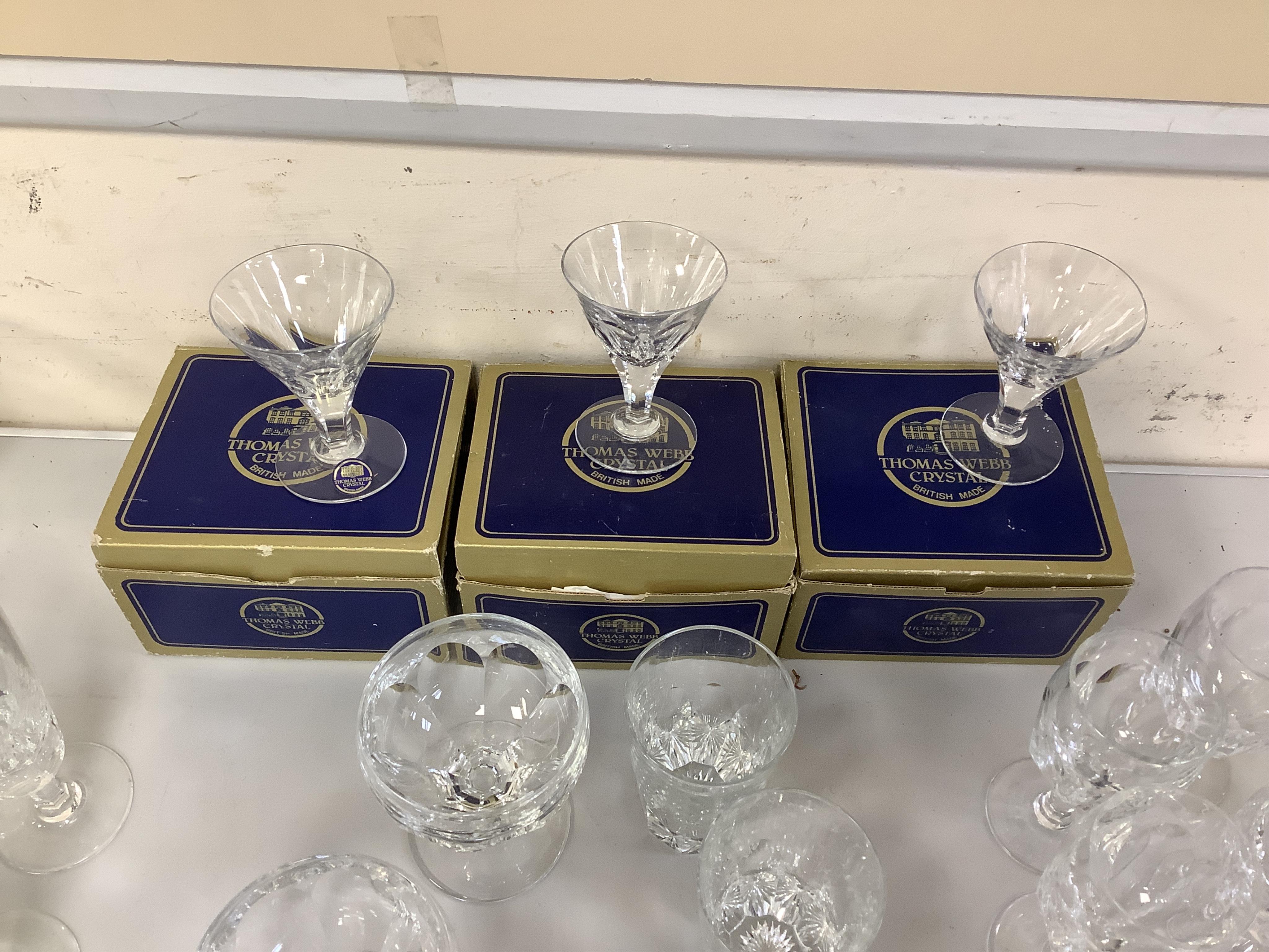 A suite of Thomas Webb Crystal wine glasses, Royal Yacht pattern, including two decanters, eight goblets, white wines and clarets, sixty-four pieces. Condition - mostly good